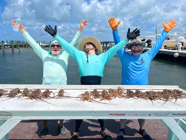 A Happy Group Of People Sharing Their Fishing Experience At Florida Keys Marinas.