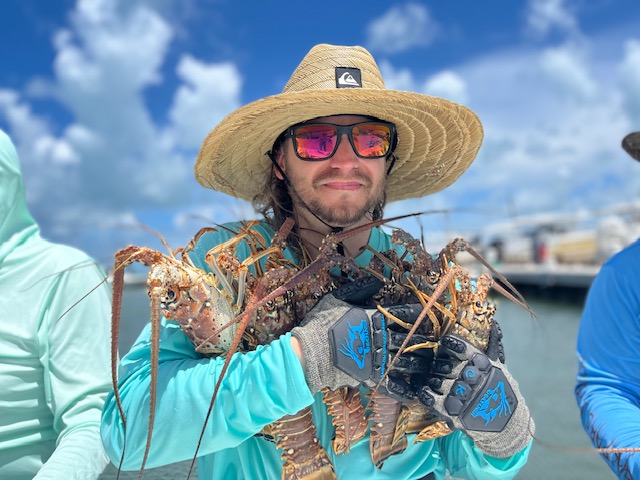 A Hat-wearing Man Boasting About His Lobster Catch
