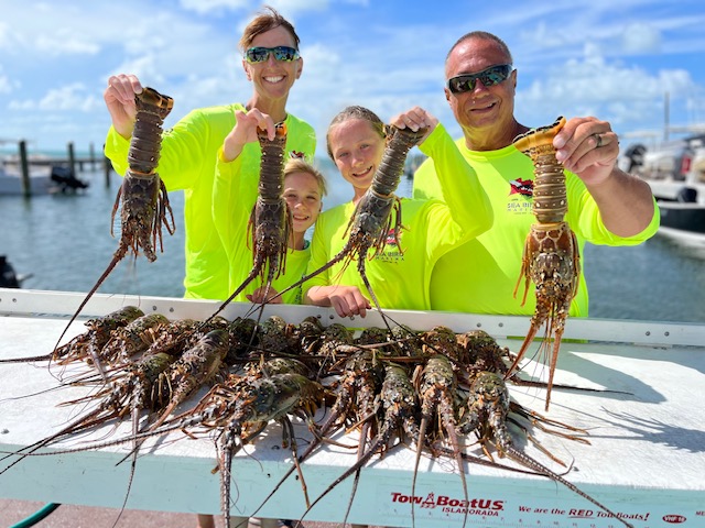 Visitors to Sea Bird Marina Display Caught Lobster in Florida